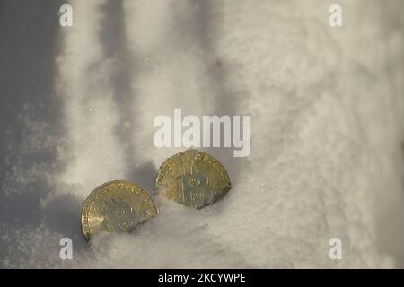 Illustratives Bild von zwei Gedenkbitcoins im Schnee. Am Donnerstag, den 6. Januar 2021, Kanada. (Foto von Artur Widak/NurPhoto) Stockfoto