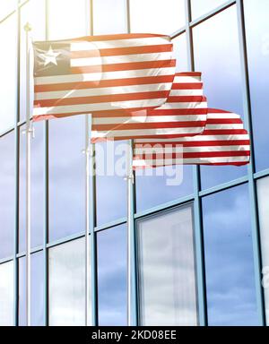 Fahnenmasten mit der Flagge Liberias vor dem Business Center Stockfoto