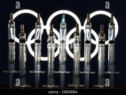 Illustratives Foto von medizinischen Spritzen, das vor dem Logo der Olympischen Ringe auf einem Computerbildschirm zu sehen ist. Am Donnerstag, den 14. Januar 2021, Kanada. (Foto von Artur Widak/NurPhoto) Stockfoto