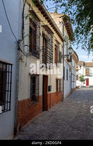 Granada, Spanien - 28. Oktober 2022: Schmale Straße in Granada, Spanien am 28. Oktober 2022 Stockfoto