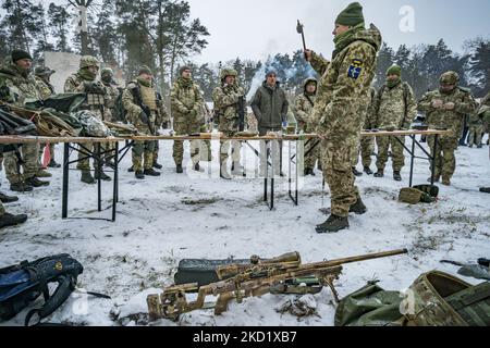 Der Armeetrainer der Territorialen Verteidigungsbrigade von Kiew 112. hält eine deaktivierte Granate mit einem Stock während des Unterrichts einer militärischen Übung für Zivilisten in den Außenbezirken der Stadt. Das Verteidigungsministerium schuf in den Hauptstädten Verteidigungsbrigaden, weil die hohe Spannung mit dem Aufbau russischer Truppen an seiner Grenze und die Gefahr einer Invasion durch Russland besteht. (Foto von Celestino Arce/NurPhoto) Stockfoto