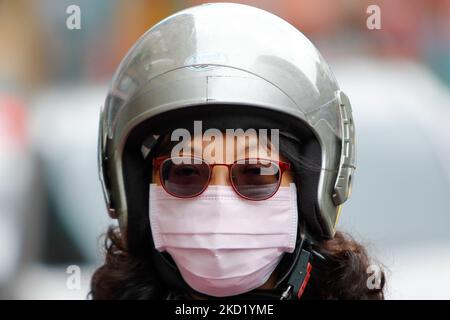 Ein Motorradfahrer mit Gesichtsmaske wartet in Taipei auf Ampeln, während die taiwanesischen Gesundheitsbehörden nach einem Sprung in lokalen Fällen die Null-Covid-Politik verfolgen, Omicron in den Gemeinden einzudämmen, in Taipei, Taiwan, 6. Februar 2022. Orte in Asien wie China, Hongkong und Taiwan setzen immer noch Zero-Covid-Richtlinien und strenge Virusbeschränkungen um, und einige südostasiatische Länder, darunter Thailand, Singapur und Malaysia, planen die Wiedereröffnung der Grenzen für internationale Reisen, wobei die USA und Großbritannien an den Live-with-Covid-Strategien festhalten. (Foto von Ceng Shou Yi/NurPhoto) Stockfoto