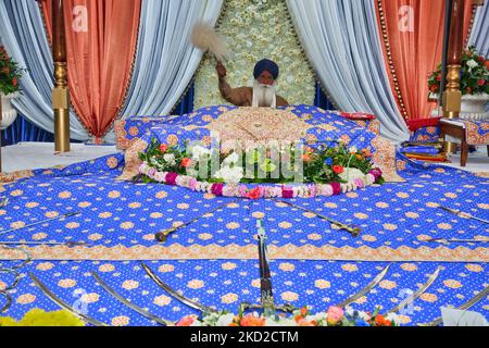 Ein Granthi verehrt den Sri Guru Granth Sahib (Sikh-Buch) in einem Gurdwara (Sikh-Tempel) während des Gurpurab (Jahrestag von Guru Nanaks Geburtstag) am 04. November 2017 in Mississauga, Ontario, Kanada. Guru Nanak Gurpurab, auch bekannt als Prakash Utsav von Guru Nanak, feiert die Geburt des ersten Sikh-Gurus, Guru Nanak. Dies ist eines der heiligsten Feste im Sikhismus. (Foto von Creative Touch Imaging Ltd./NurPhoto) Stockfoto