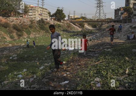 Am 19. Februar 2022 laufen Kinder über einen verschmutzten und mit Müll gefüllten Kanalteil des Buriganga-Flusses in Dhaka, Bangladesch. (Foto von Kazi Salahuddin Razu/NurPhoto) Stockfoto