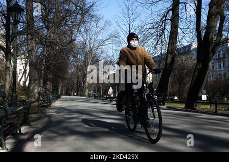 Ein Mann mit einer Gesichtsschutzmaske fährt am 1. März 2022 in Krakau, Polen, mit dem Fahrrad. (Foto von Jakub Porzycki/NurPhoto) Stockfoto