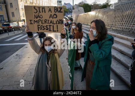 Aktivisten halten während der Kundgebung auf der Versammlung der Republik in Lissabon Zeichen gegen Krieg und den Einsatz fossiler Brennstoffe. 03. März 2022. Protest unter der Führung des Lissabon Student Climate Strike als Reaktion auf einen dringenden Aufruf am Freitag für die Zukunft der Ukraine, durch den Dutzende von Aktionen rund um den Globus organisiert werden. In Lissabon beabsichtigt das Kollektiv, "den durch den fossilen Kapitalismus provozierten Imperialismus als verantwortlich für die Finanzierung von Krieg und Gewalt nicht nur in der Ukraine, sondern auch in vielen anderen Ländern der Welt zu enttarnen". (Foto von Jorge Mantilla/NurPhoto) Stockfoto