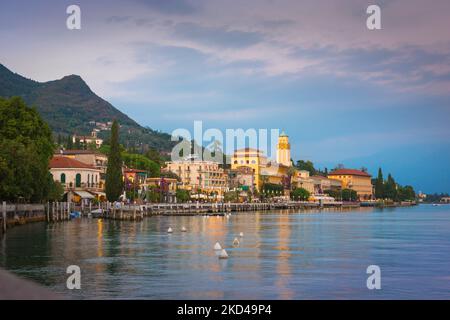 Gardasee Italien, Blick in der Dämmerung auf die malerische Seestadt Riviera Gardone auf der südwestlichen Seite des Sees, Gardasee, Lombardei, Italien Stockfoto