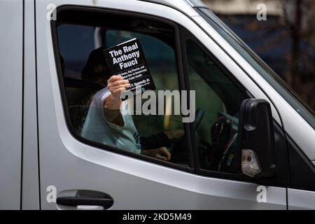 Eine Frau hält eine Kopie von Robert F. Kennedy Jr.'s Buch „The Real Anthony Fauci“, als ein kleiner Konvoi von LKW-Fahrern und Menschen, die gegen COVID-19-bezogene Mandate protestieren, am 20. März 2022 durch Washington D.C. fährt (Foto: Bryan Olin Dozier/NurPhoto) Stockfoto