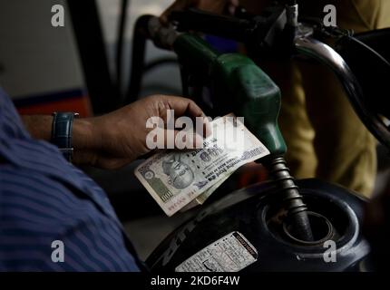 Ein Mitarbeiter einer Ölpumpe steckt eine Kraftstoffdüse in ein Fahrrad in Kalkutta, Indien, 01. April 2022. Der Benzin- und Dieselpreis in Kalkutta beträgt 111,35 Rs pro Liter und 96,22 Rs pro Liter. (Foto von Indranil Aditya/NurPhoto) Stockfoto