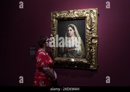 LONDON, VEREINIGTES KÖNIGREICH - 04. APRIL 2022: (EMBARGO BIS 0001 BST AM MITTWOCH, 06. APRIL 2022) Ein Mitarbeiter der Galerie blickt auf das "Portrait einer Frau ('La Donna Velata')" um 1513-14 des höchsten italienischen Hochrenaissance-Künstlers Raphael (1483-1520) während eines Fotobesuchs zur Ausstellung der Credit Suisse: Raphael in der National Gallery am 04. April 2022 in London, England. Die Ausstellung ist eine der ersten, die alle Aspekte von Raphaels Karriere untersucht, darunter berühmte Gemälde und Zeichnungen sowie Architektur, Poesie, Skulptur, Wandteppiche und Drucke. (Foto von Wiktor Szymanowicz/NurPhoto) Stockfoto