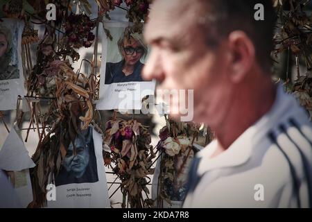 Die Menschen gehen an einer Blumenwand vorbei, auf der Bilder von ukrainischen Opfern der russischen Invasion in Warschau am 17. Mai 2022 zu sehen sind. Der Konflikt hat in der nach der UNO so genannten größten humanitären Krise in Europa seit den jugoslawischen Kriegen im Jahr 1990s etwa 8000 Tausend Tote und mehr als 6 Millionen Erwiderungen verursacht. (Foto von STR/NurPhoto) Stockfoto