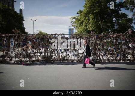 Die Menschen gehen an einer Blumenwand vorbei, auf der Bilder von ukrainischen Opfern der russischen Invasion in Warschau am 17. Mai 2022 zu sehen sind. Der Konflikt hat in der nach der UNO so genannten größten humanitären Krise in Europa seit den jugoslawischen Kriegen im Jahr 1990s etwa 8000 Tausend Tote und mehr als 6 Millionen Erwiderungen verursacht. (Foto von STR/NurPhoto) Stockfoto