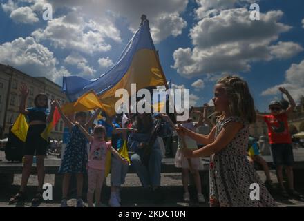 Svetlana Nikonorova, eine ukrainische Sängerin und Bandura-Spielerin, umringt von Kindern, spielt während des Protestes ein Lied. Mitglieder der lokalen ukrainischen Diaspora, Kriegsflüchtlinge, Friedensaktivisten, Freiwillige und lokale Unterstützer während des 109.-tägigen „Protestes der NATO Close the Sky“ am Adam-Mickiewicz-Denkmal auf dem Hauptplatz in Krakau. Am Sonntag, den 12. Juni 2022, in Krakau, Polen. (Foto von Artur Widak/NurPhoto) Stockfoto