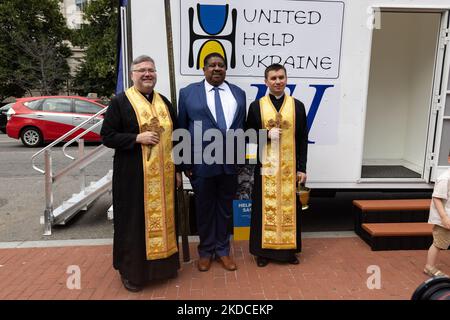 Pater Robert, links, und Pater Andrii, rechts, vom Ukrainischen Katholischen Nationalheiligtum der Heiligen Familie, Mitte, posieren für ein Foto mit Dexter Myers, Senior Vice-President von Pacific Engineering Inc., Zentrum, während einer Zeremonie am Holodomor Memorial in Washington, D.C., am 21. Juni, 2022 Ankündigung der Spende einer umfunktionierten mobilen medizinischen Klinik für Lastwagen für einen schnellen Einsatz in der Ukraine. (Foto von Bryan Olin Dozier/NurPhoto) Stockfoto