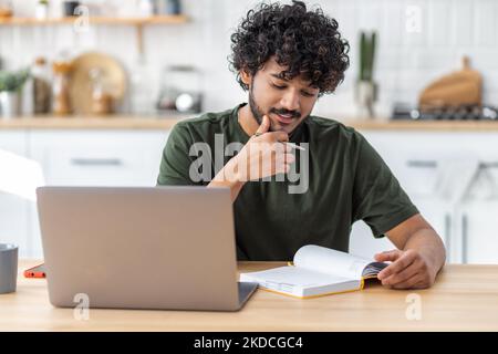 Fernunterricht, Online-Bildung. Porträt eines lächelnden jungen freiberuflichen oder studentischen Mannes, der ein Webinar oder eine Schulung anschaut Stockfoto