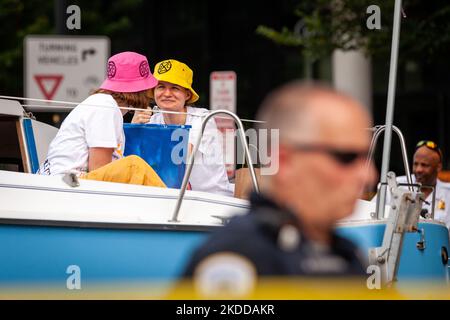 Zwei Mitglieder von Extinction Rebellion DC besetzen ein Boot, das den Verkehr hinter einem Polizisten der Metropolitan (DC) blockiert, während einer Straßenparty, die im Rahmen der Kampagne „End Methan, Electrify DC“ der Gruppe veranstaltet wird. Die Partei protestiert gegen den Ausbau der Infrastruktur für fossile Brennstoffe durch Washington Gas sowie gegen die Rolle des Unternehmens bei Methanlecks, die derzeit DC heimsuchen. Methan ist das stärkste Treibhausgas, das die globale Erwärmung antreibt und 80-mal effektiver Wärme einschließt als Kohlendioxid im Laufe von 20 Jahren. (Foto von Allison Bailey/NurPhoto) Stockfoto