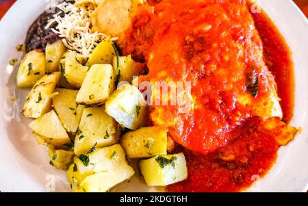 Mexikanisches Omelett mit schwarzen Bohnen Kartoffeln und Nachos auf weißem Teller in El Cafecito in Zicatela Puerto Escondido Oaxaca Mexiko. Stockfoto