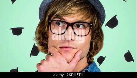Digitales Composite-Bild eines nachdenklichen jungen Kaukasiers mit Brille und Hut Stockfoto