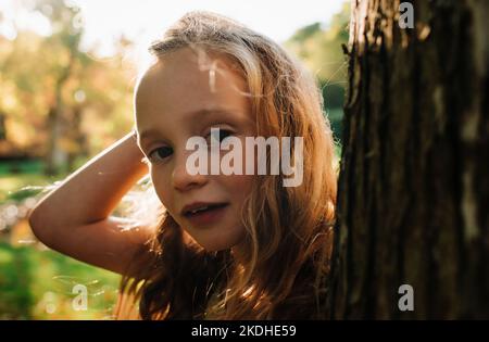 Nahaufnahme eines Kindes zur goldenen Stunde im Wald Stockfoto