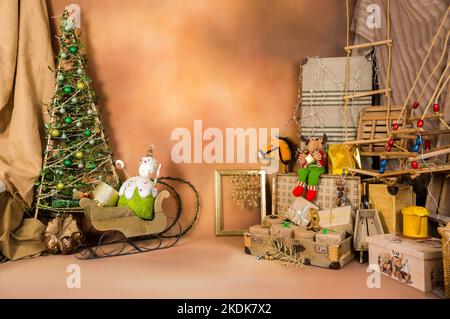 Weihnachtsdekoration mit Spielzeug und Ornamenten auf braunem texturierten Hintergrund. Stockfoto