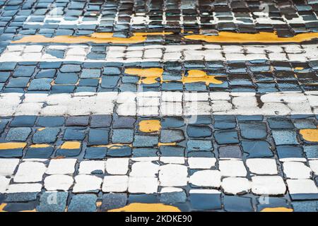 Fußgängerübergang mit Kopfsteinpflaster Straße, niemand.Alte Stein Textur aus der Nähe. Abstrakter Hintergrund Stockfoto