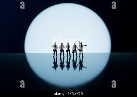 Road Block Polizei oder Armeekräfte gegen weißen runden Kreis Lichtkonzept Bilder - niedrige Mini-Spielzeug Figuren der Sicherheitskräfte - Silhouette von ar Stockfoto