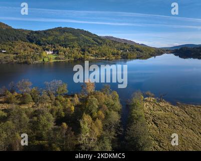 Luftaufnahme von Loch Achray in den Trossachs mit Tigh More Timeshare-Schloss und -Gelände an einem wunderschönen Herbsttag. Stockfoto