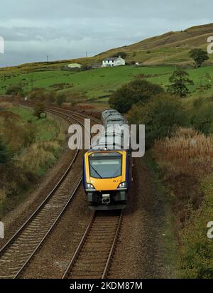 Die dmu eines Northern-Zuges hat den Gipfel der Burnley-Linie nach Todmorden bei Copy Pit passiert, während er unterhalb der New Hay Farm in der Nähe von Portsmouth verläuft. Stockfoto