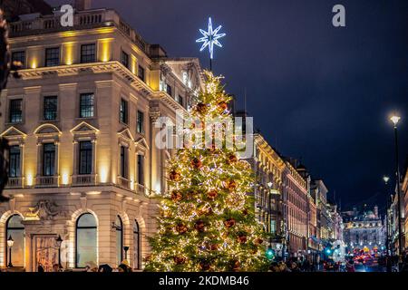 London, Großbritannien. 17. August 2022. Blick auf einen Weihnachtsbaum am Waterloo Place in London. Auf einigen Straßen in London wurden am 2.. November Weihnachtslichter eingeschaltet. Das Vereinigte Königreich wurde vor der Möglichkeit von Stromausfällen in diesem Winter in dem unwahrscheinlichen Szenario, dass die Stromversorgung ausläuft, gewarnt. Das Einkaufsviertel der Oxford Street bietet den ganzen Tag und die ganze Nacht über eine schillernde Ausstellung. In diesem Jahr werden sie jedoch nur von 3:00 Uhr bis 11:00 Uhr eingeschaltet, um weniger Energie zu verbrauchen und Geld zu sparen. Quelle: SOPA Images Limited/Alamy Live News Stockfoto