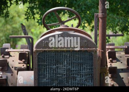 Eine Nahaufnahme eines antiken McCormick-Deering Landtraktors, der den Namen über dem Kühler zeigt. Das Hotel liegt in einem Feld im ländlichen NE Pennsylvania.. Stockfoto