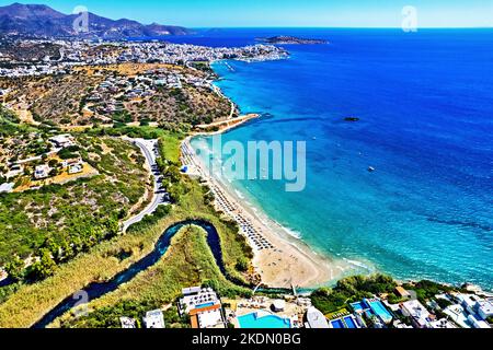 Luftaufnahme (Drohne) des Strandes von Almyros (und des Feuchtgebiets) in der Nähe der Stadt Agios Nikolaos (im Hintergrund), der Präfektur Lasithi, Kreta, Griechenland. Stockfoto