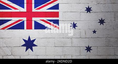 Australische weiße Ensignflagge auf einer Backsteinmauer gemalt. Stockfoto