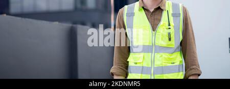 Portrait junger Kaukasischer ist Architekt, der Projekt und Plan auf der Baustelle plant und inspektiert, Ingenieur männlich arbeitet und auf Deve prüft Stockfoto