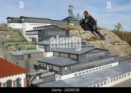 Wernigerode, Deutschland. 08.. November 2022. Ein Mitarbeiter steht vor dem Modell des Bergwerks Rammelsberg. Im Miniaturpark endete die Besuchersaison am 06. November. Die Modelle zahlreicher Harzer Sehenswürdigkeiten werden in den kommenden Tagen gelagert. Bis zur Eröffnung der Saison im nächsten Jahr werden die witterungsbedingten Schäden repariert. Im Laufe des Jahres konnten mehr als 130000 Besucher im Bürger- und Miniaturpark begrüßt werden. Quelle: Matthias Bein/dpa/Alamy Live News Stockfoto