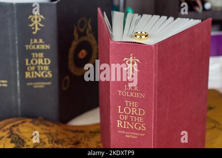 Astrachan, Russland - 11.09.2022: Der Goldene Ring der Macht liegt auf dem rot dicken Buch der Herr der Ringe Stockfoto