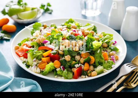 Salat aus Tabbouleh. Tabouli-Salat mit frischer Petersilie, Zwiebeln, Tomaten, Bulgur und Kichererbsen. Gesunde vegetarische Lebensmittel, Ernährung Stockfoto