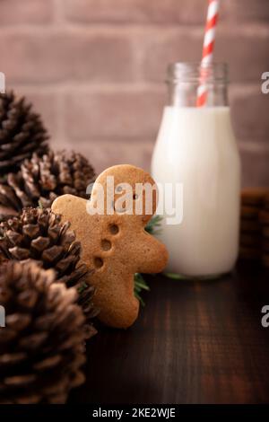 Hausgemachter, lächelnder Lebkuchenmann, der hinter einer Pinecone herauspießt. Diese Cookies werden traditionell in der Weihnachtszeit zu Weihnachten hergestellt. Stockfoto