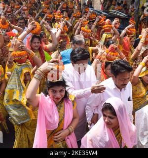 Neu Delhi, Indien April 03 2022 - Frauen mit Kalash am Kopf während des Jagannath-Tempels Mangal Kalash Yatra tragen indische Hindu-Anhänger irdische Töpfe Conta Stockfoto
