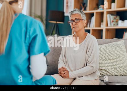 Krankenschwester, ältere Frau und Beratung auf dem Sofa zu Hause für die Gesundheitsuntersuchung oder Untersuchung. Gesundheitswesen, Beratung und Ärztin mit älteren Patienten Stockfoto