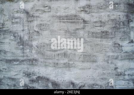 Alte verputzte Steinwand. Schmutziger grauer Hintergrund. Stockfoto