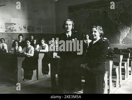 Klassenfoto im Klassenzimmer mit zwei Lehrern, Deutschland 1940s Stockfoto