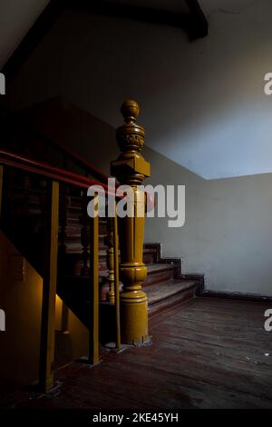 Das Innere einer Holztreppe in einem alten Wohnhaus. Foto aufgenommen bei Tageslicht. Stockfoto