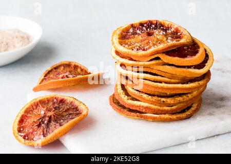 Ein Stapel hausgemachter, dehydrierter, gewürzter Blutorangenscheiben. Stockfoto