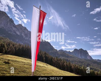 Südtiroler Flagge hinterleuchtet vor dem Dolomitenpanorama Stockfoto