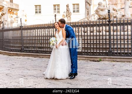 Ein frisch verheiratetes sizilianisches Paar posiert für Hochzeitsfotos am Pretoria-Brunnen, Palermo, Sizilien, Italien. Stockfoto