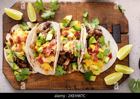 Frühstück Tacos mit Würstchen, Eiern, Speck und Avocado Stockfoto