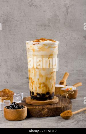 Boba oder Tapioka Perlen ist taiwan Bubble Milchtee in Kunststoff-Tasse mit Milchtee-Geschmack auf Textur Hintergrund, Sommer Erfrischung. Stockfoto