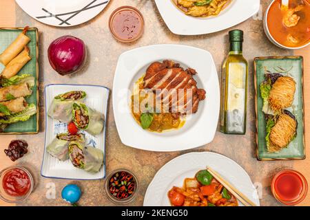 Gerichte mit großen asiatischen Rezepten, gebratene vietnamesische Brötchen, Rindernudeln und Austernsauce, gebratene pekinente, Gemüsegudeln, Entennudeln, Garnelentemperatur Stockfoto