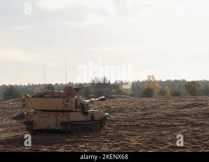 NATO verstärkte Vorwärtspräsenz Battlegroup Polen US-Soldaten zugewiesen zu 2. Zug, Bull Battery, 2. Bataillon, 82. Field Artillery Regiment, 3. Bataillon, 8. Kavallerie Regiment, 3. Panzerbrigade Kampfteam, 1. Kavallerie Division (3-1 ABCT) operativ von der 1. Infanterie Division (1 ID) gesteuert, Neupositionierung der M109A7 Paladin Haubitzen und M992 Field Artillery Ammunition Support Vehicle während der Live-Feuerübung in Toruń, Polen, 3. November 2022. Die 3-1 ABCT ist unter anderem der 1 ID zugeordnet und arbeitet stolz mit NATO-Verbündeten und regionalen Sicherheitspartnern zusammen Stockfoto