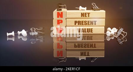 Business and law concept. On a black reflective surface lie buttons and wooden plaques with the inscription - Net Present Value Stockfoto